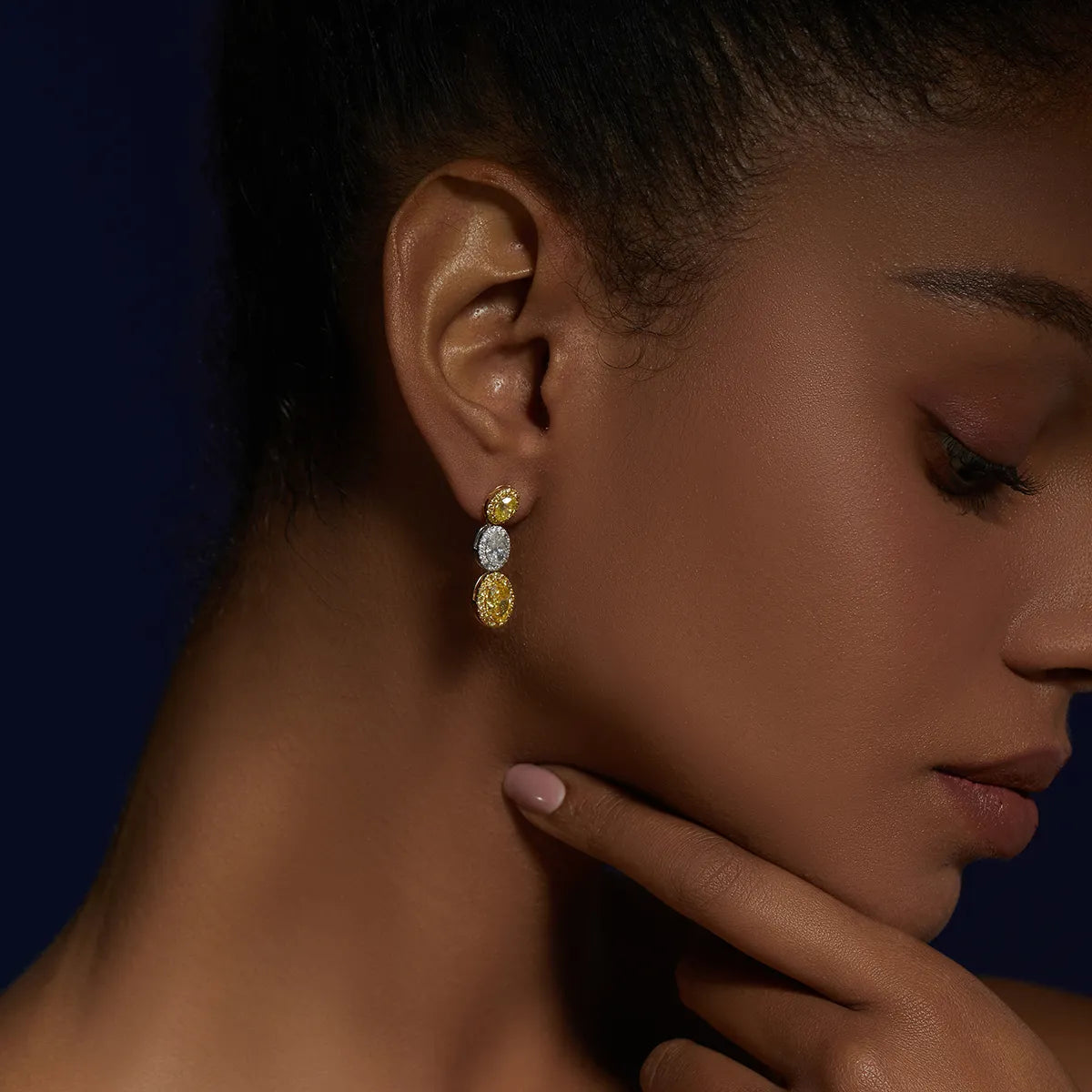 4.4 Carat Oval Cut Halo Three Stone Fancy Yellow Lab Grown Diamond Drop Earrings.