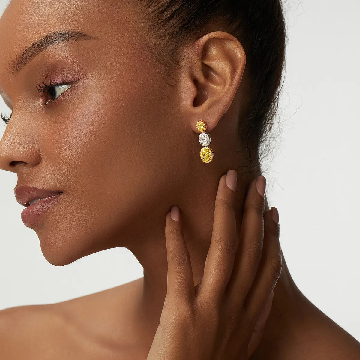 4.4 Carat Oval Cut Halo Three Stone Fancy Yellow Lab Grown Diamond Drop Earrings.