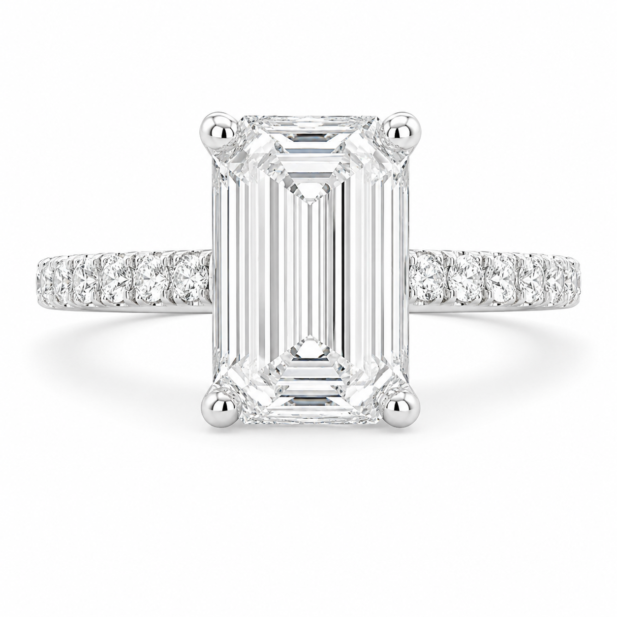 An emerald-cut diamond ring with a silver-toned pavé band, shown on a clean white background.