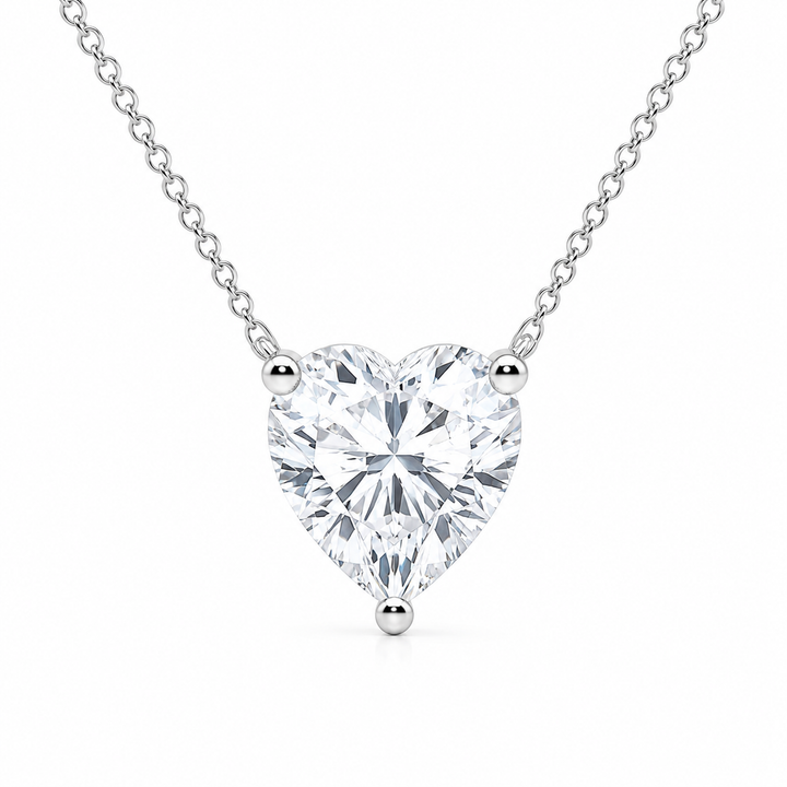 Heart-shaped diamond pendant on a chain against a white background