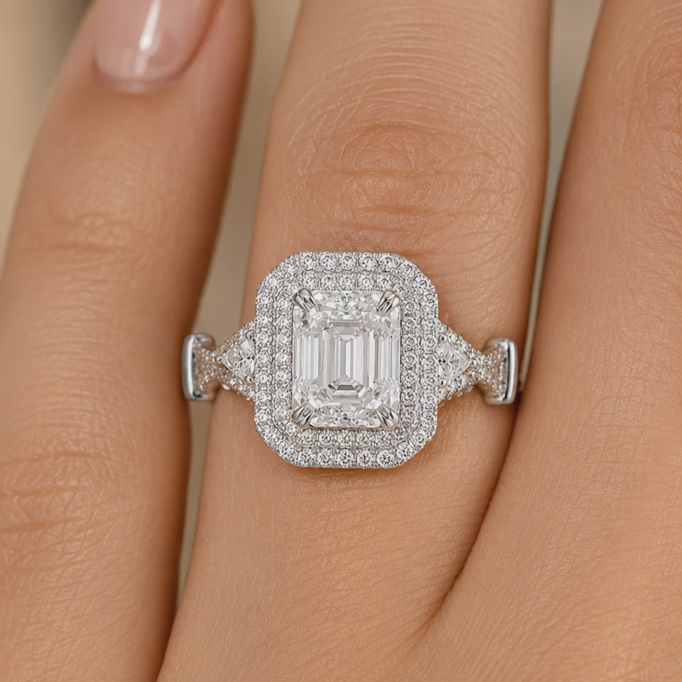 2.50 CT Emerald Cut Lab-Grown Diamond Double Halo Engagement Ring in 14K White Gold – Triangle Side Stone Twisted Shank Design