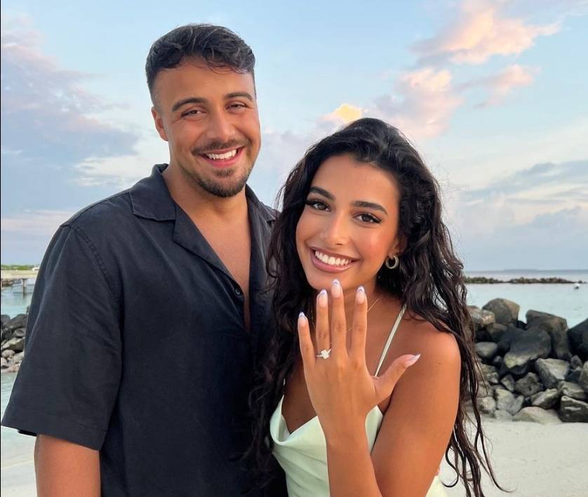 Happy couple wearing engagement ring